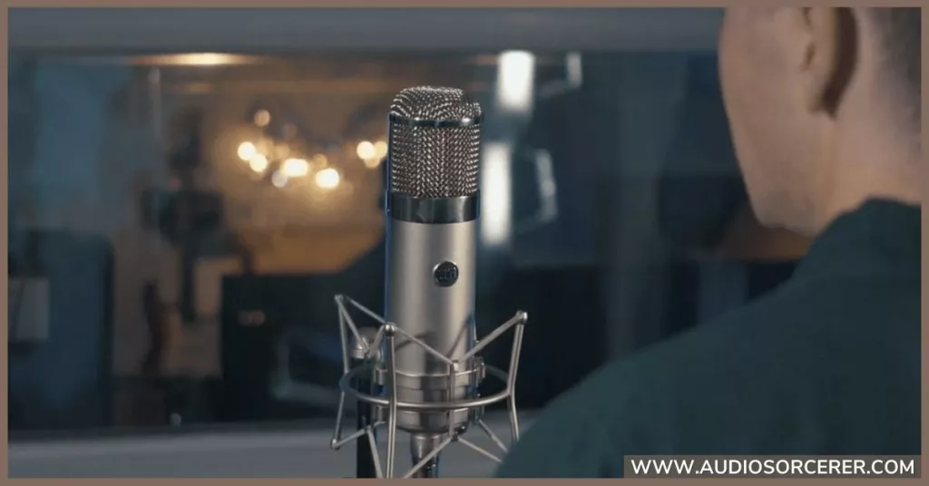 Man singing into a Warm Audio WA-47 microphone in a recording studio.