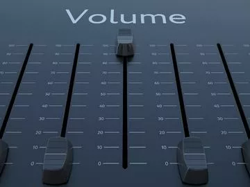 Faders on a mixing console with the word "volume" at the top.