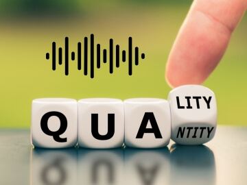 The word quality spelled out in dice with an audio waveform above them.