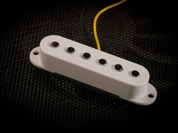 White single coil guitar pickup with a wire coming out of it.