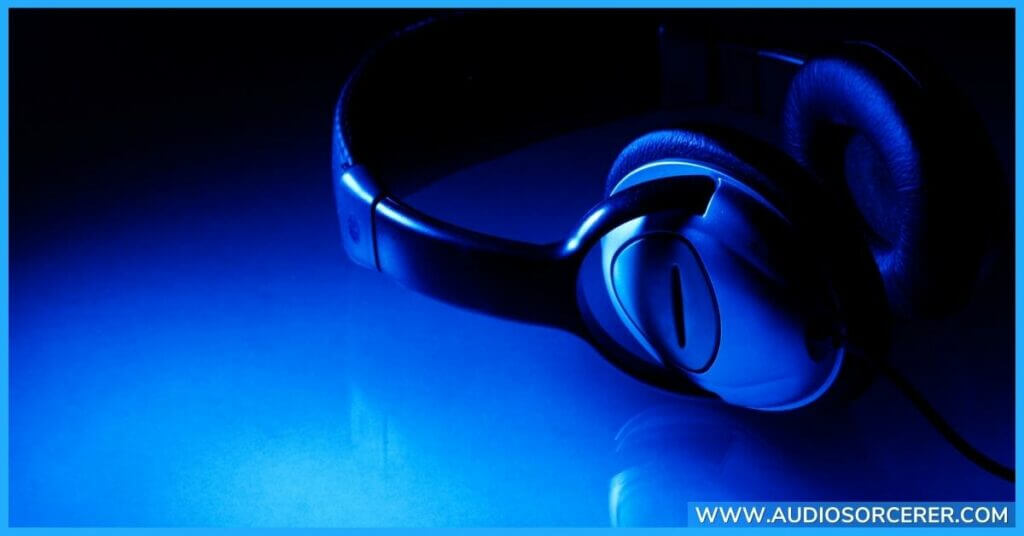 Black headphones on a blue table.