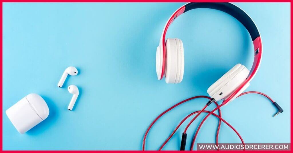 Wireless earbud headphones and wired headphones on a blue background.