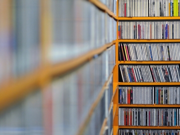 A bunch of music CDs representing Flowkey's large library of music.
